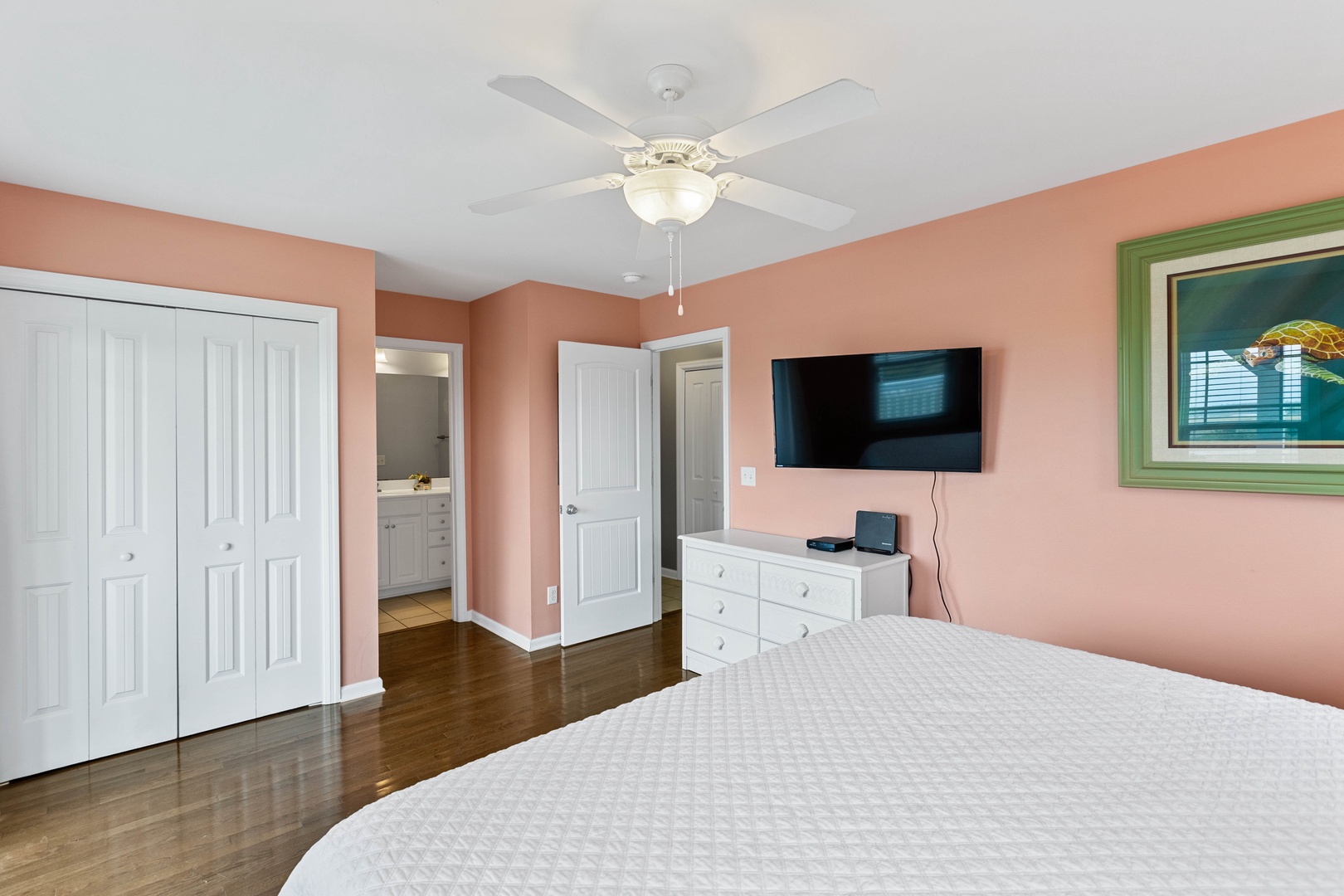 Bedroom 2 with a king-sized bed, Smart TV, balcony access, and an ensuite bathroom