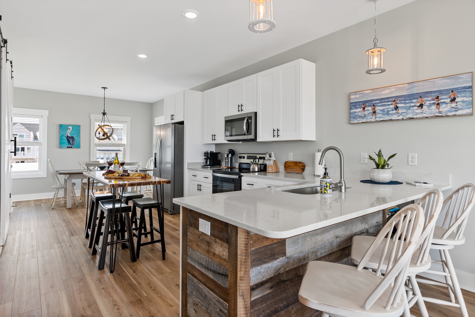 The well-stocked kitchen with countertop seating for 3 and island seating for 4