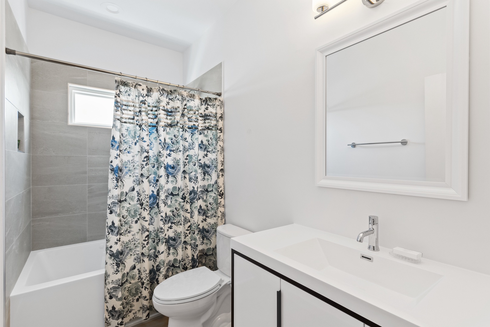 Shared bathroom with a shower-tub combination