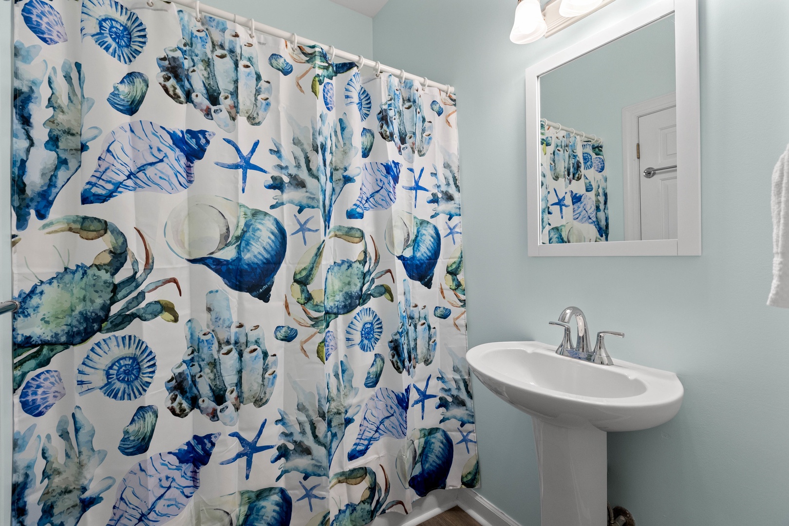 The ensuite bathroom with a shower-tub combination