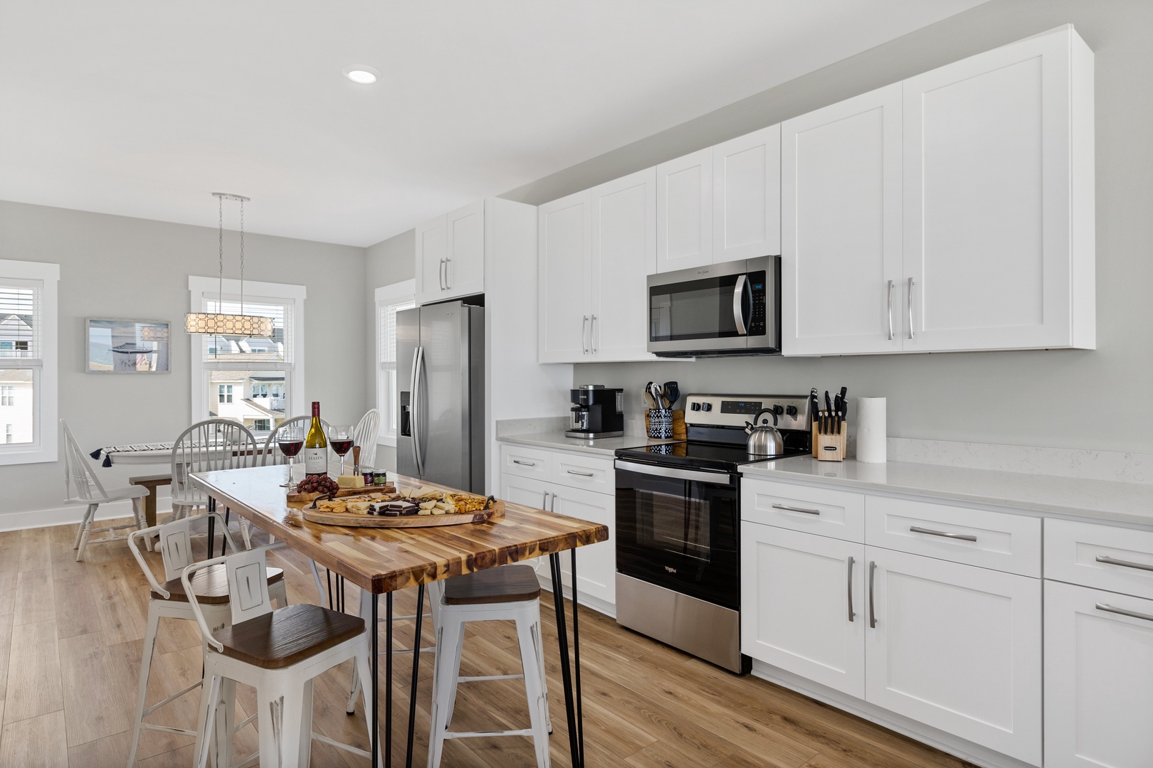 The well-stocked kitchen with countertop seating for 3 and island seating for 4