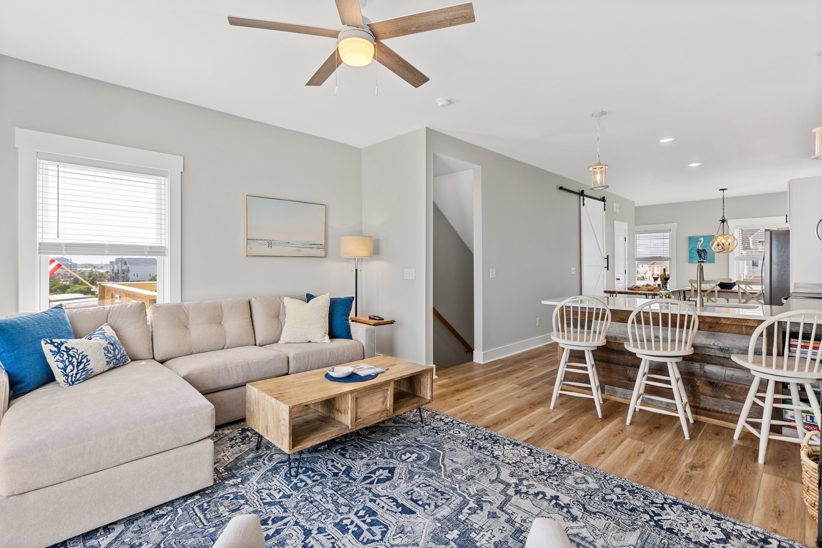 The living area with a Smart TV and ocean view balcony access