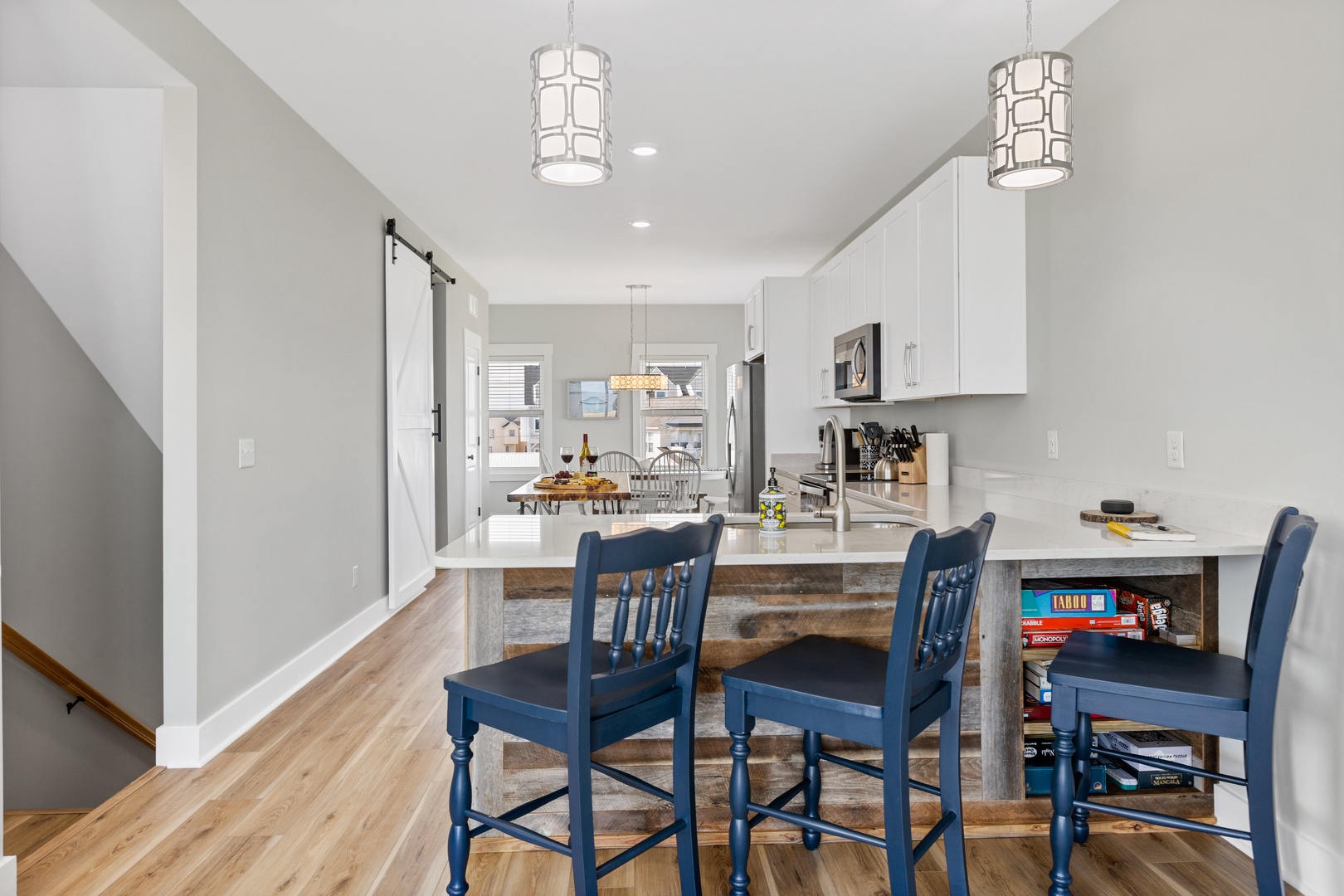 The well-stocked kitchen with countertop seating for 3 and island seating for 4