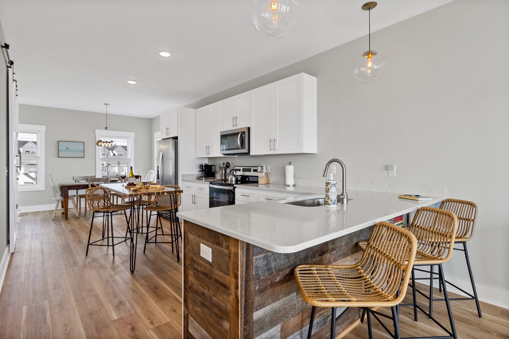 The well-stocked kitchen with countertop seating for 3 and island seating for 2
