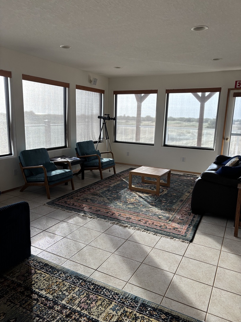 You'll love this bright dining space with its cozy seating and beautiful Persian rug, perfect for sharing meals.