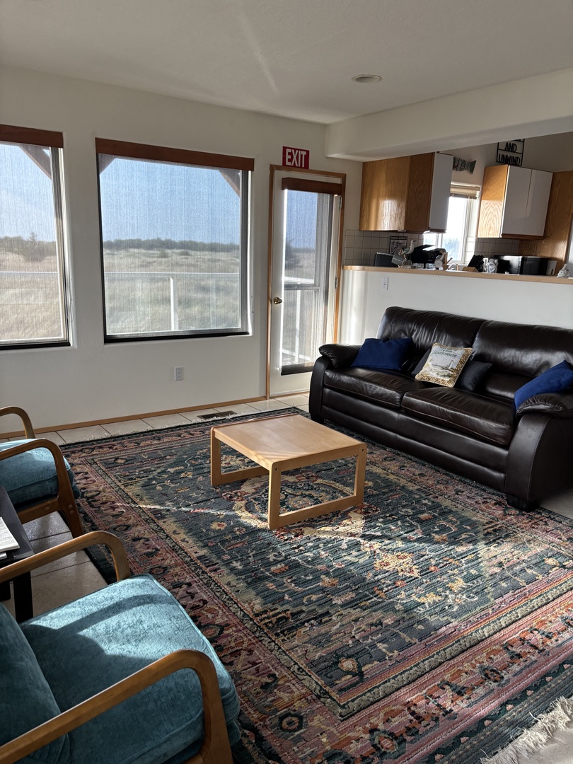 Relax in your comfortable living space with plush leather seating and beautiful traditional rugs underfoot.