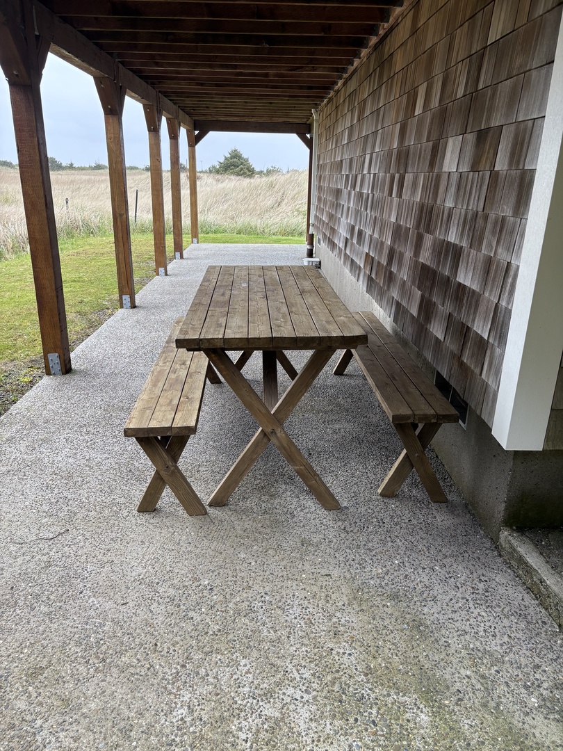 Step onto your private covered terrace where rustic wooden beams frame peaceful views of rolling countryside beyond.