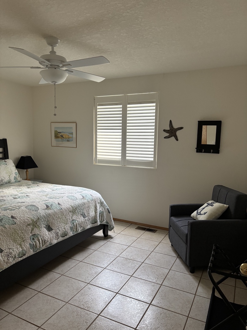 Sink into your cozy bedroom sanctuary with coastal touches and natural light streaming through the blinds.