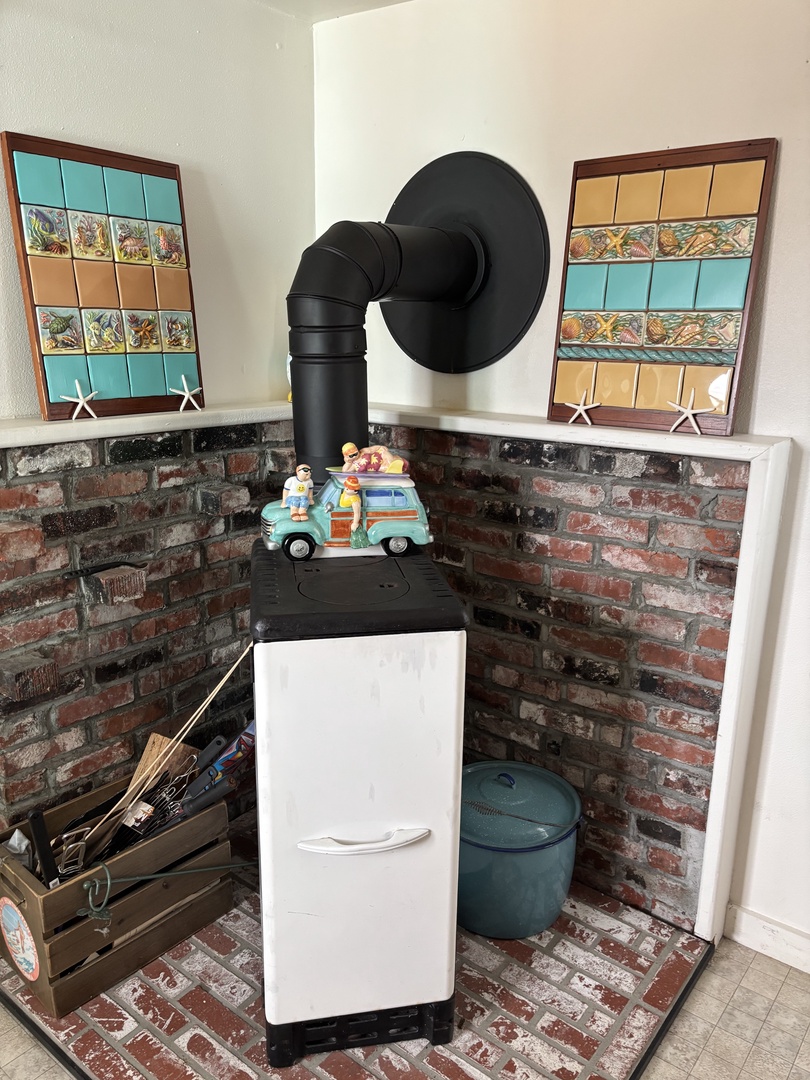 Step into your private bathroom where rustic exposed brick meets playful coastal charm, featuring decorative tile accents with starfish and beach scenes to set a cheerful seaside tone.