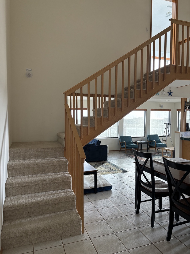 Unwind in your stylish dining space with warm wood accents, modern furniture, and natural light streaming through large windows.