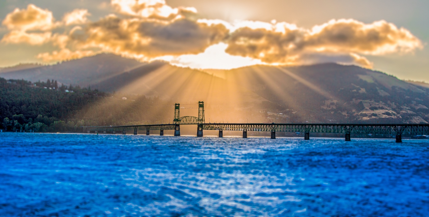 The iconic Hood River bridge spans the Columbia River at sunrise