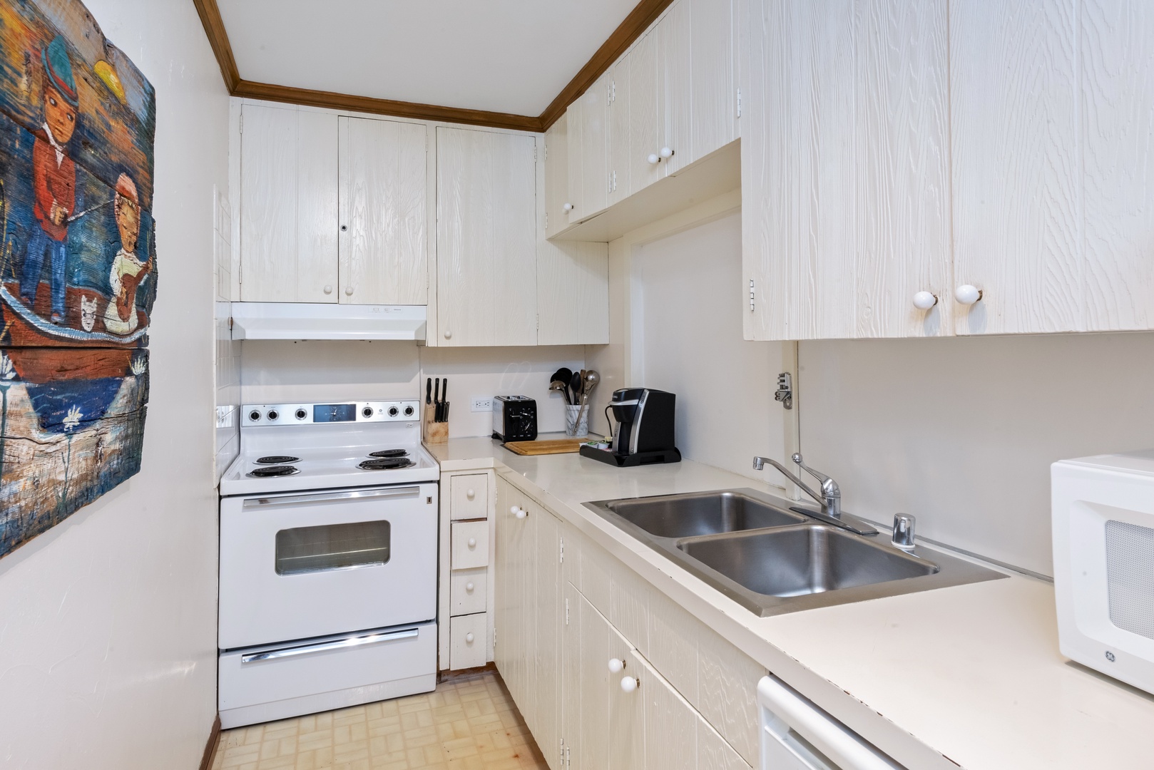 Your fully equipped kitchen awaits with bright cabinetry, double sink, and all the appliances you need to prepare meals in your home away from home.