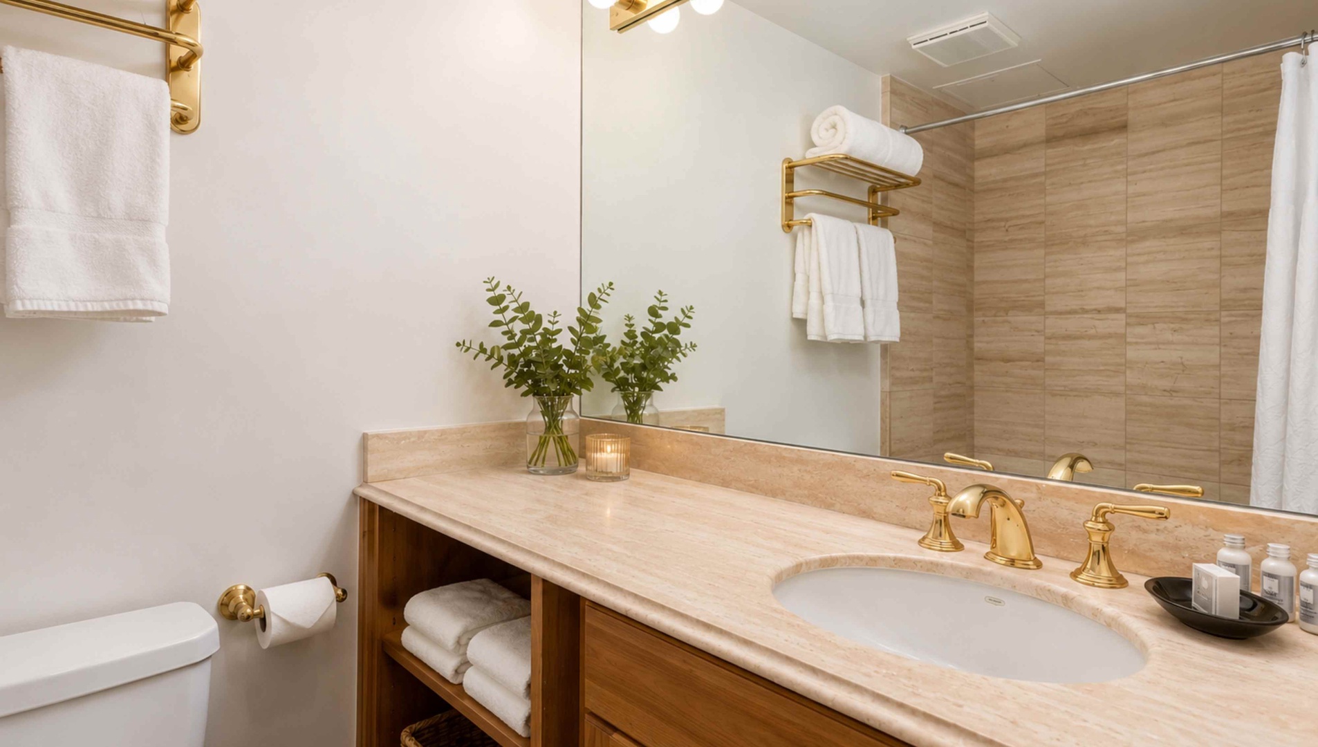 Step into your elegantly appointed bathroom with gleaming marble countertops, gold fixtures, and plush towels awaiting. A serene space where every detail has been thoughtfully curated for your comfort.