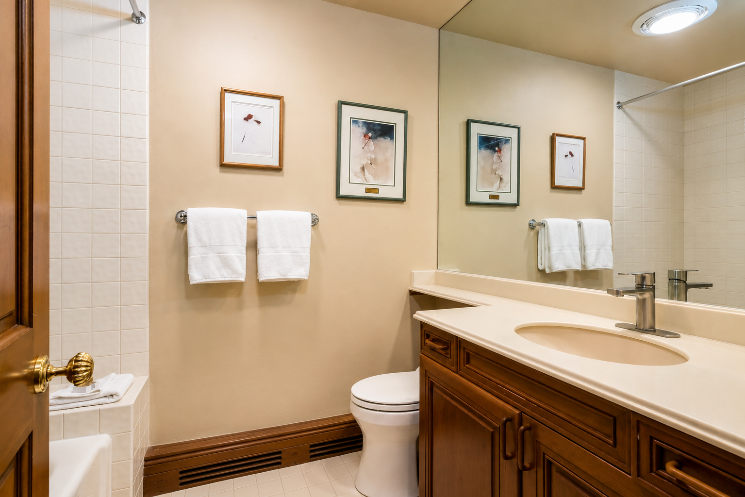 Step into your private bathroom with warm wood vanity, fresh towels, and modern fixtures—your serene space to refresh and unwind after a day of adventure.