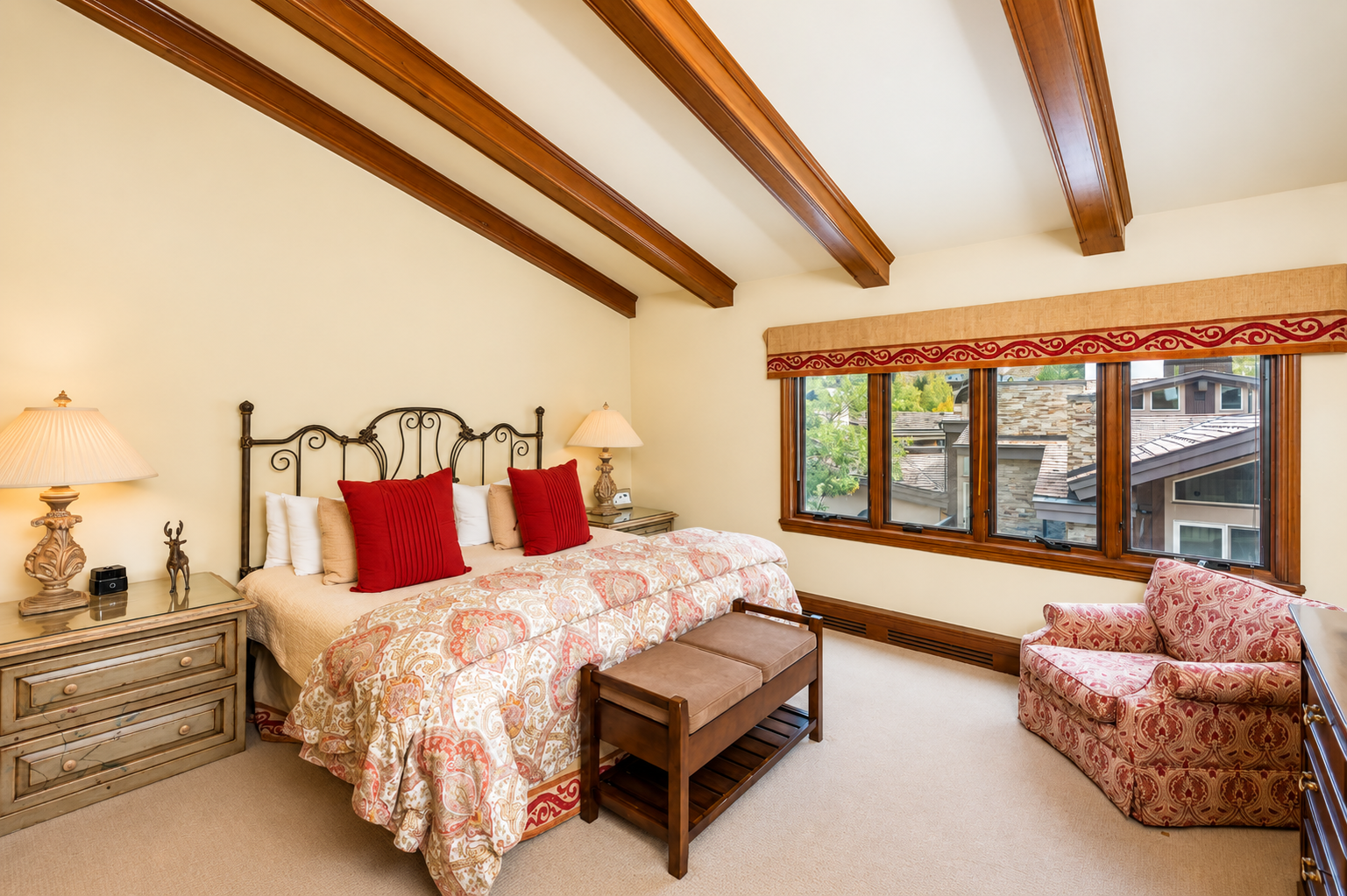 Curl up in your cozy bedroom, where vaulted wood ceilings and warm natural light create a peaceful mountain retreat.