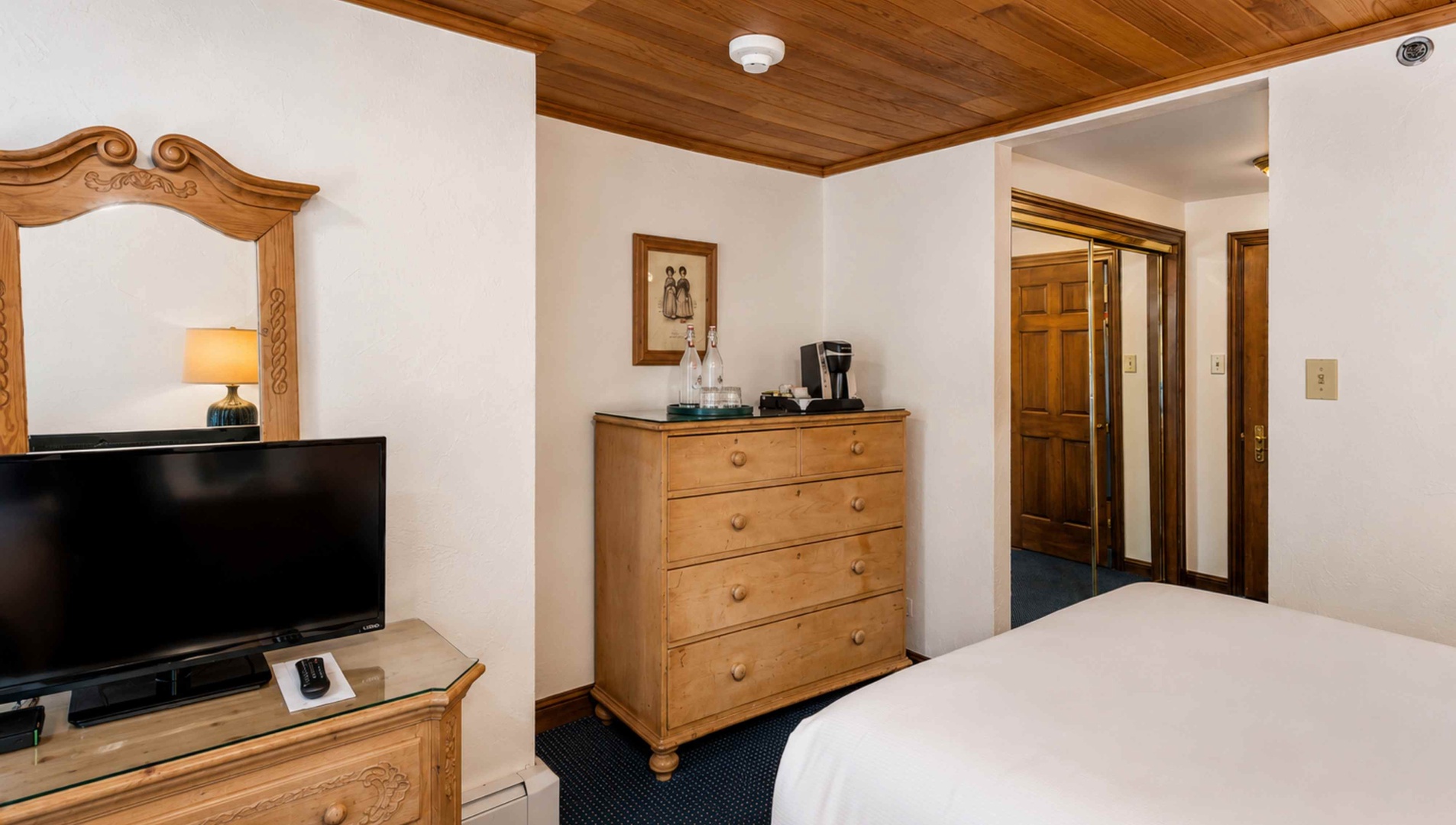 Settle into your cozy retreat with warm wood accents, a flat-screen TV for unwinding, and a coffee maker to start your mornings just right.