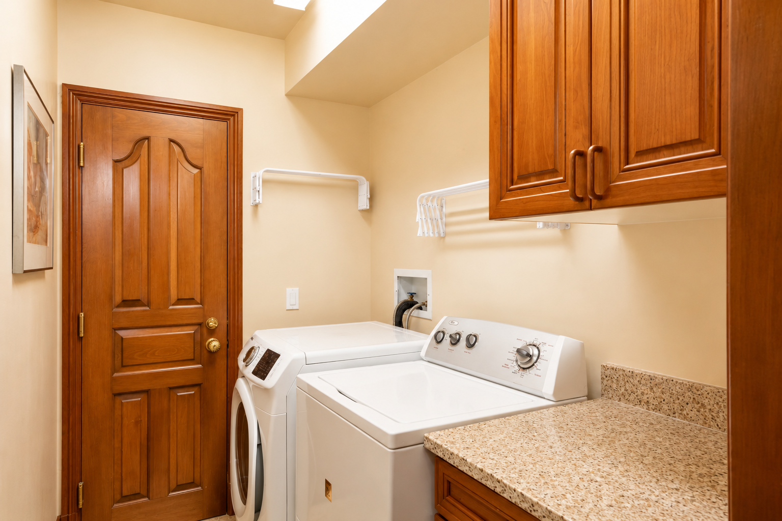 This well-equipped laundry room offers modern appliances and ample storage for your convenience during your stay.