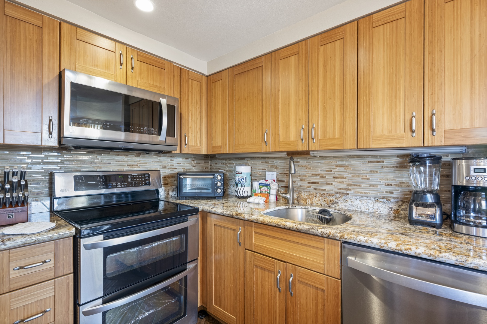 Your fully-equipped kitchen features warm wood cabinetry, granite countertops, and stainless appliances—everything you need to cook up vacation memories or prep quick bites between adventures.