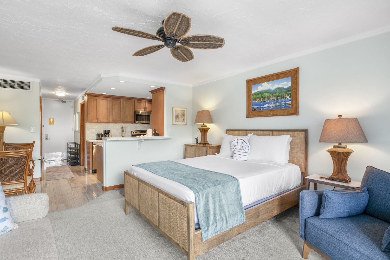 Relax in your coastal-inspired suite featuring a plush bed, stylish furnishings, and your own kitchenette for added convenience during your stay.
