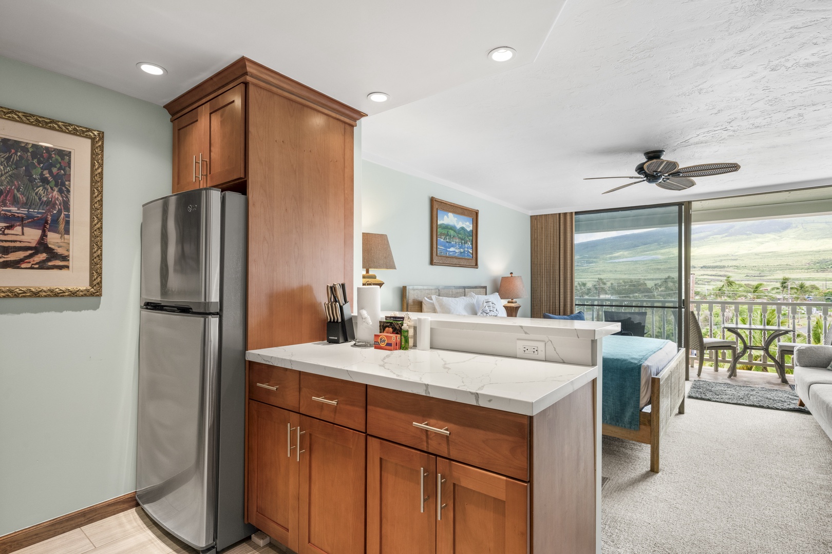 Your open-concept suite blends kitchen convenience with bedroom comfort. Mountain vistas await beyond your private balcony, where morning coffee meets island serenity.