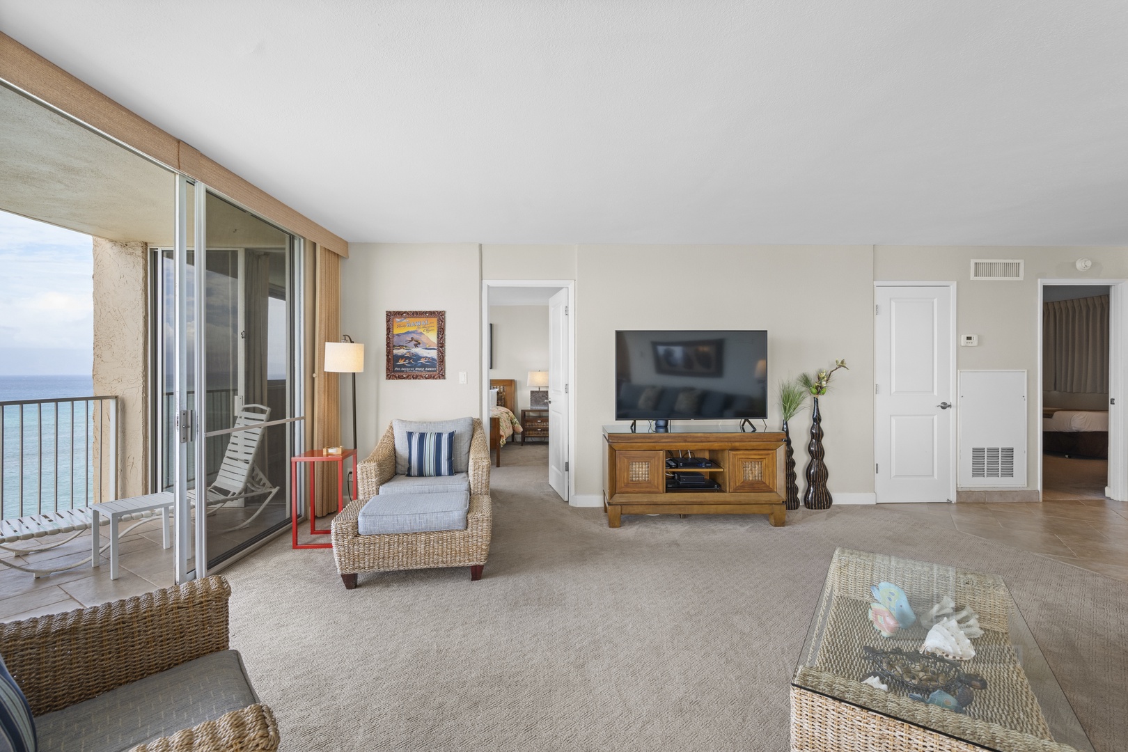 Relax in your spacious living room with ocean views, where coastal breezes drift through sliding doors to your private balcony.