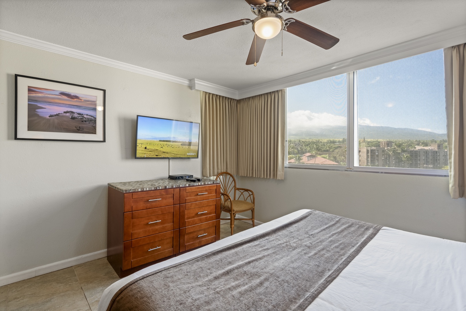 Drift off to restful sleep in your bright corner bedroom, cooled by a gentle ceiling fan and framed by sweeping mountain vistas stretching across the horizon.