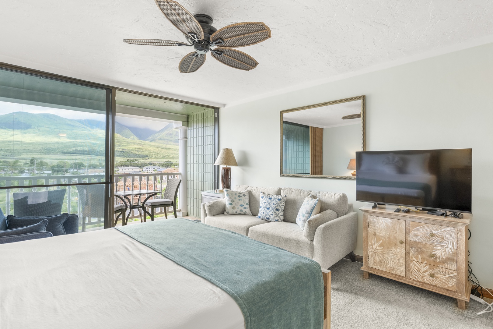 Unwind in your private retreat with a plush bed, cozy seating, and sweeping mountain views from your personal balcony—your perfect escape awaits.