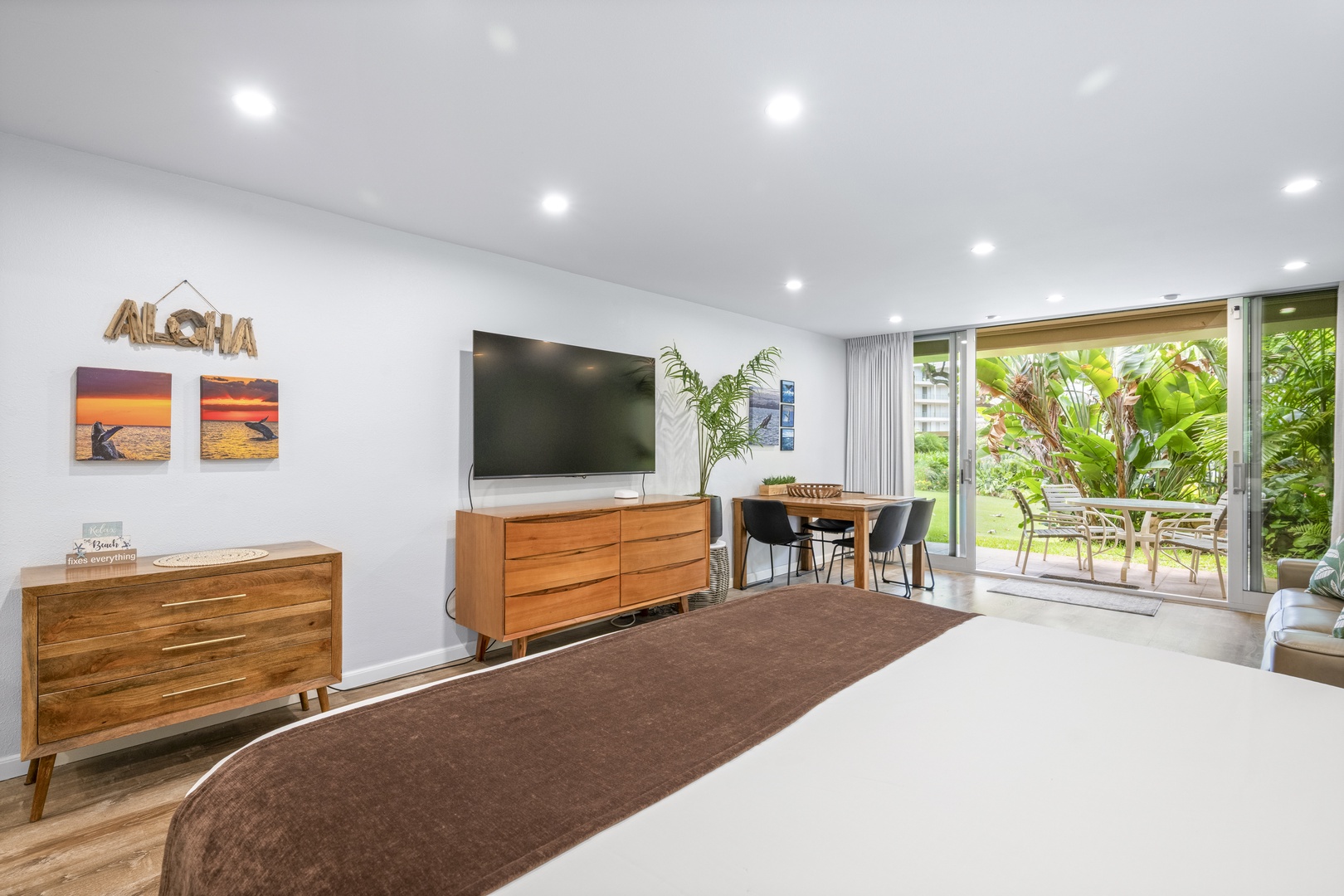 Slide open the glass doors and step onto your private patio surrounded by lush tropical greenery—perfect for sipping morning coffee or unwinding after island adventures.