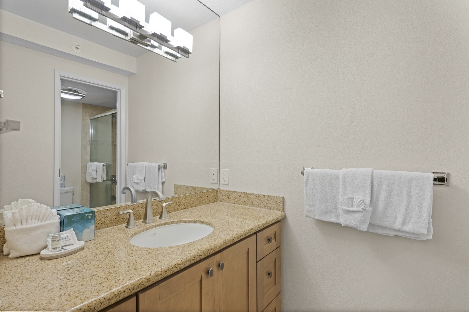 Your spacious bathroom features granite counters, modern fixtures, and fresh towels for your comfort.