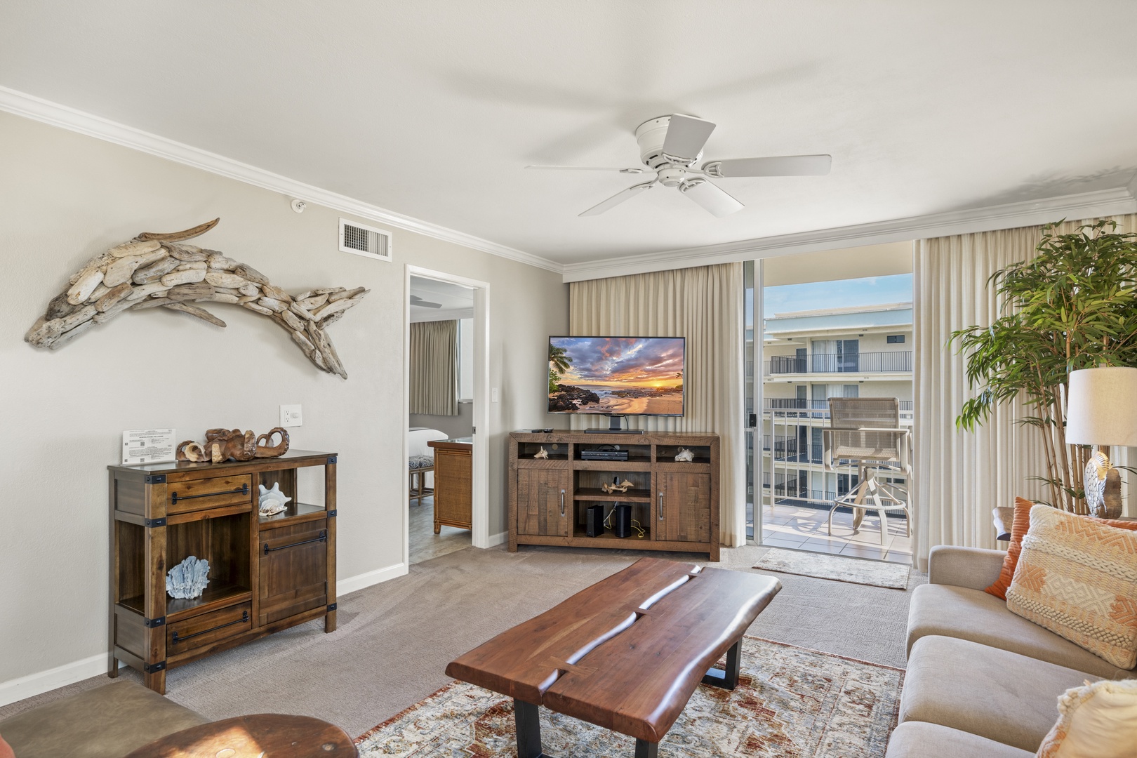 Unwind in this coastal-inspired living room where natural textures and warm wood tones create a relaxing retreat. Step through the sliding glass door to your private balcony and enjoy the sunshine.