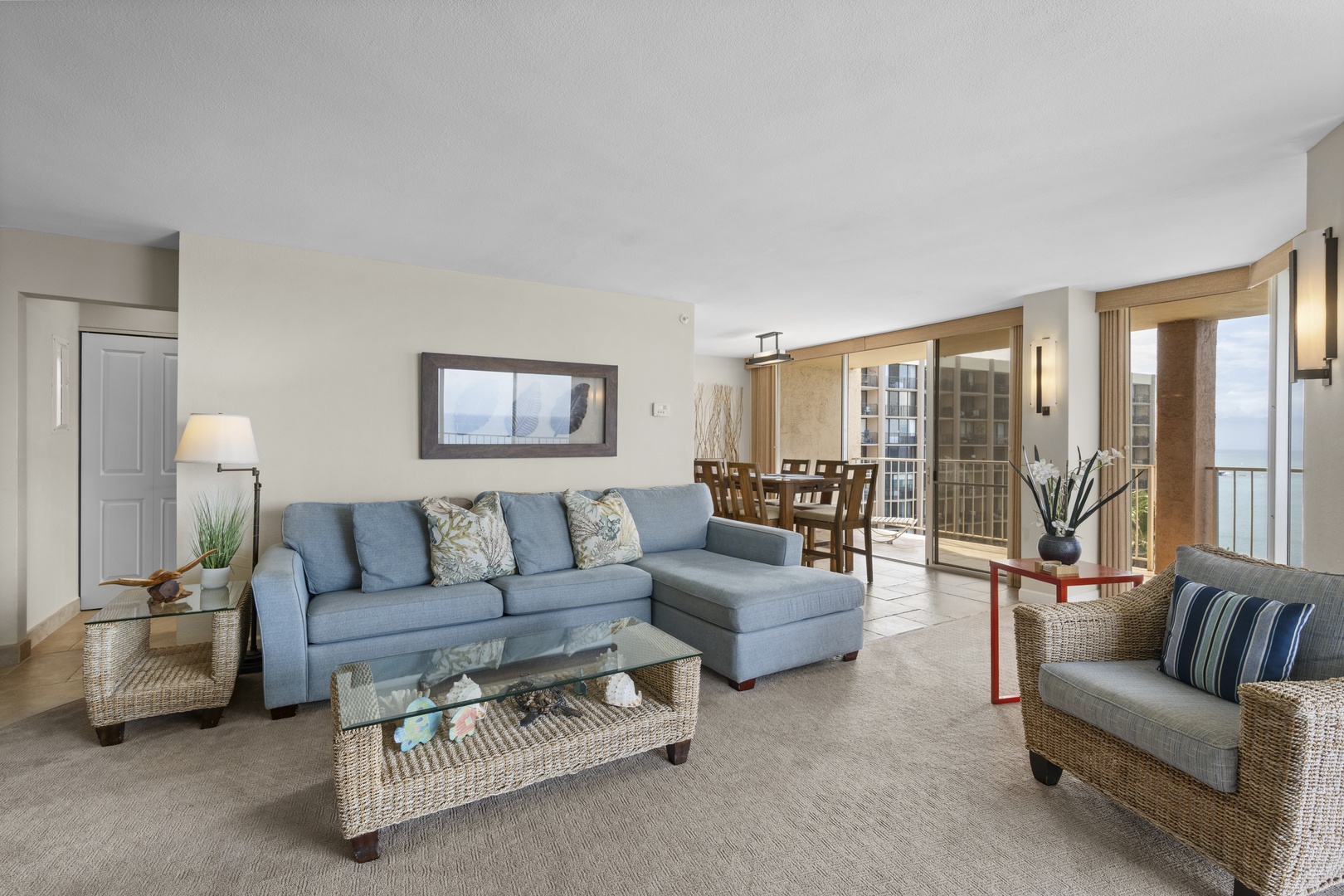 Sink into the plush blue sectional and enjoy your open-concept living space with ocean views from the private balcony.