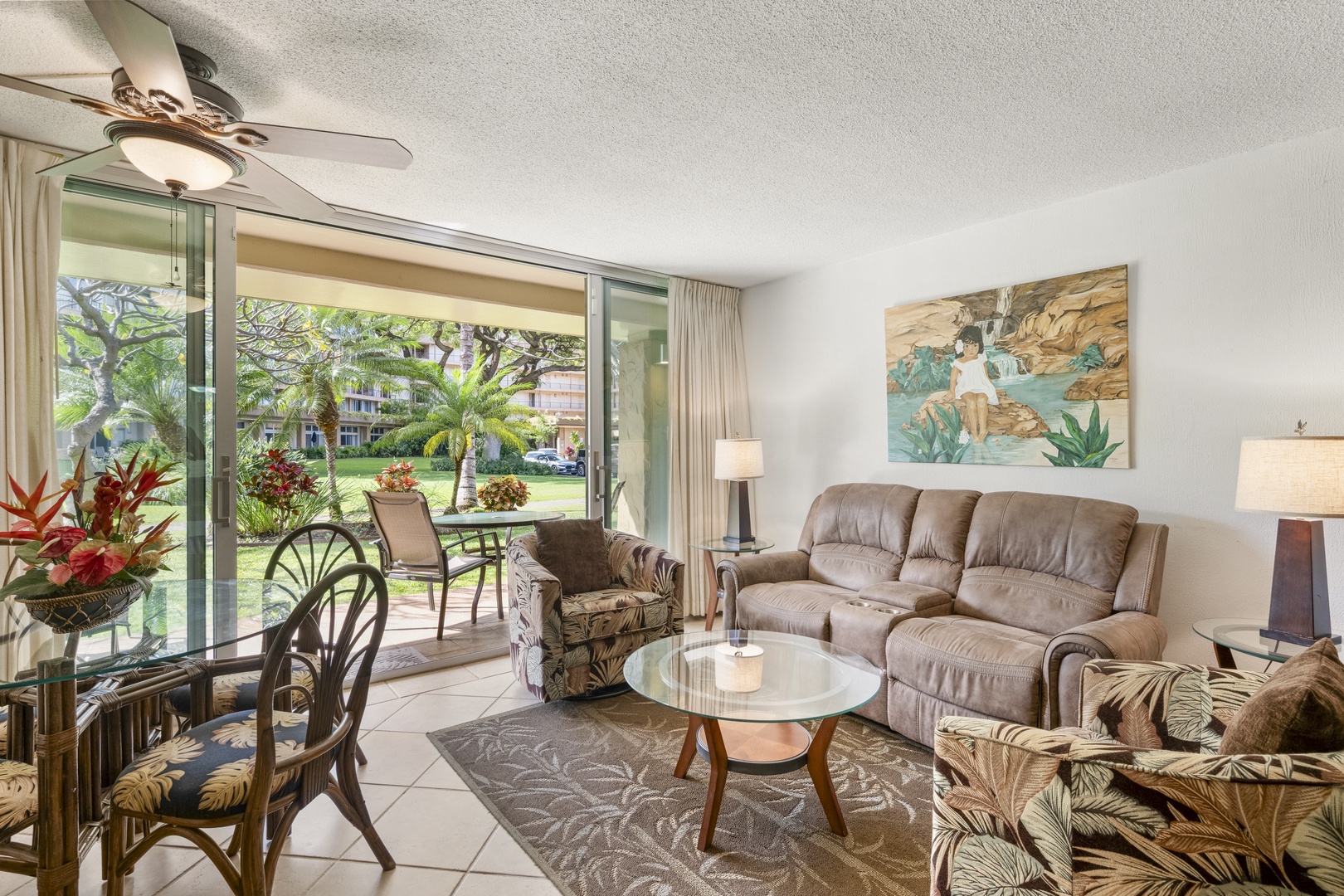 Sink into your cozy living room and enjoy garden views through wide sliding doors. Tropical artwork and fresh breezes make this your perfect island retreat.
