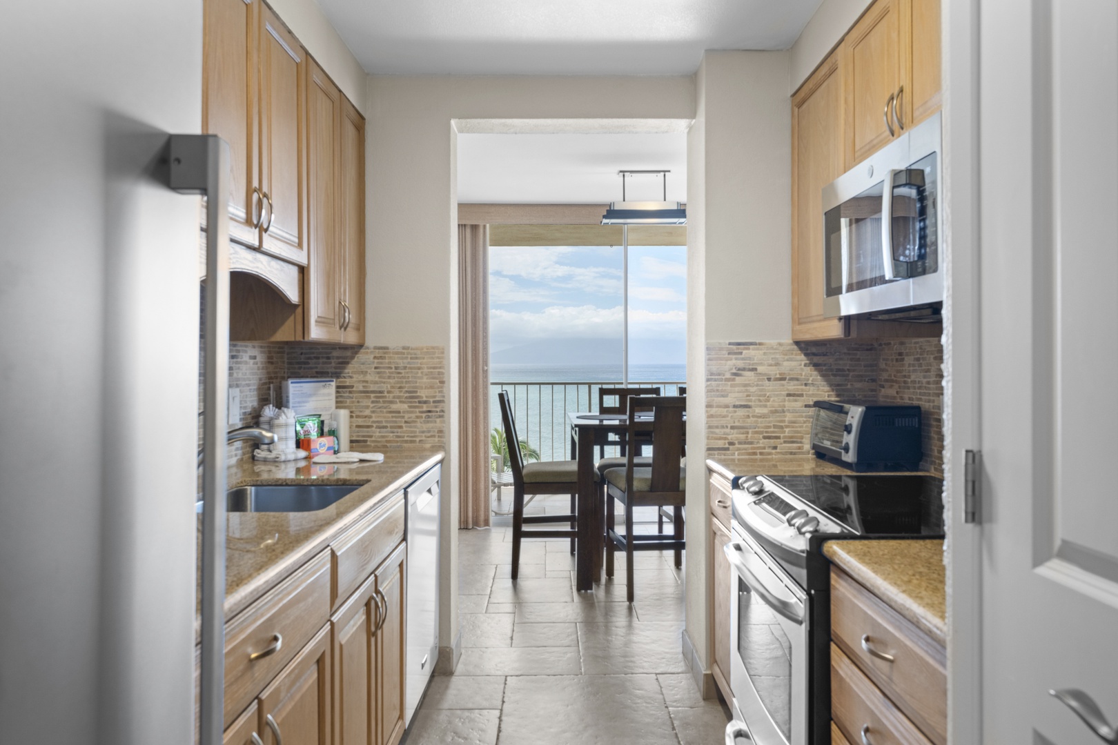 Your spacious galley kitchen offers everything you need to create memorable meals, with ocean views beyond the dining area.