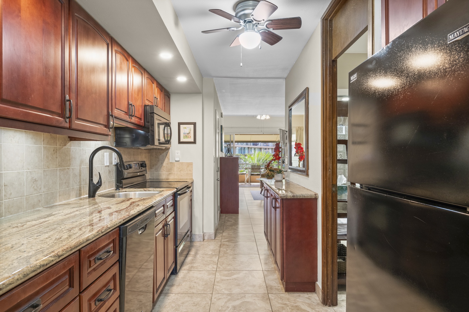 Your fully equipped kitchen offers rich wood cabinetry, granite counters, and modern appliances—perfect for preparing delicious meals during your stay.