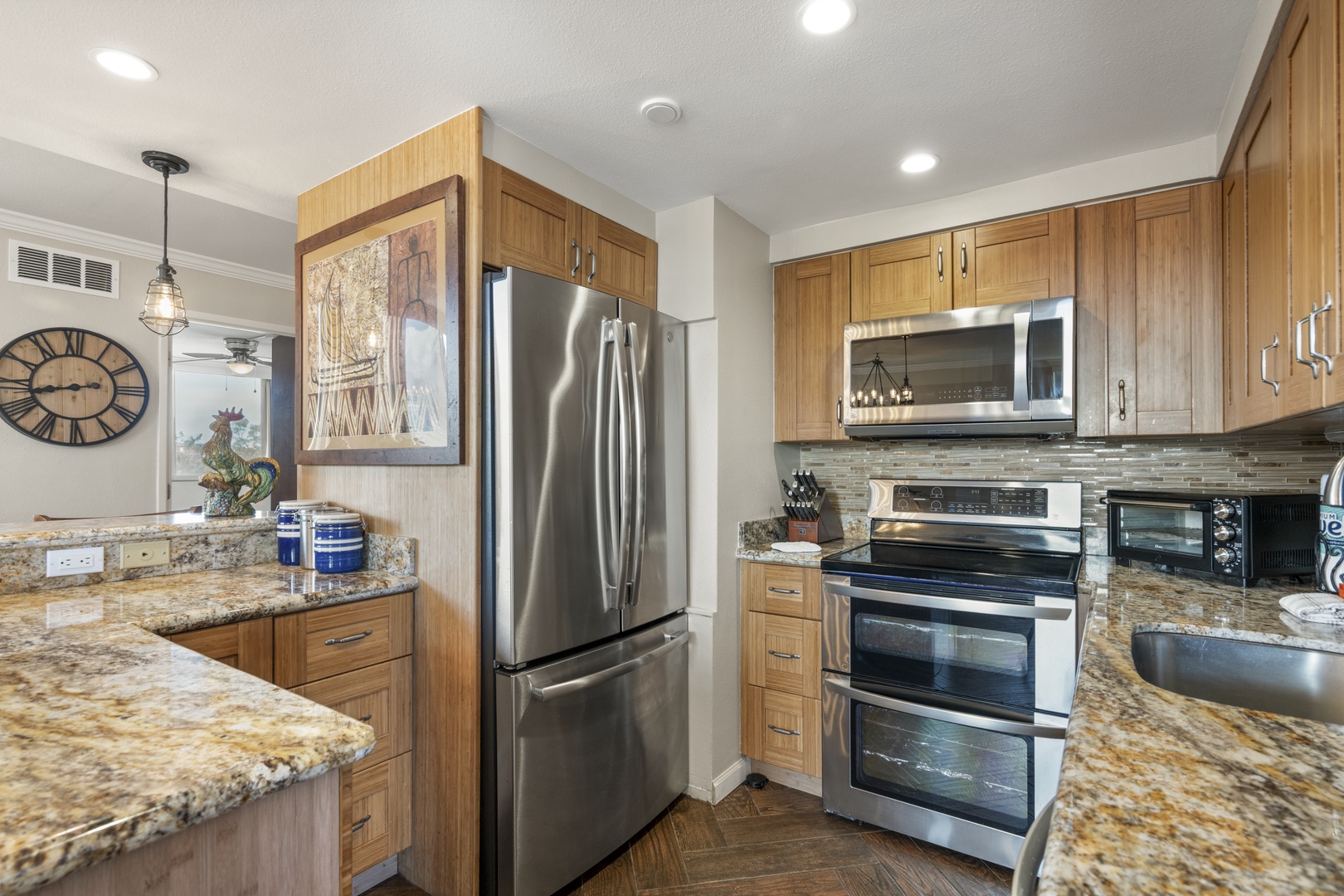 Your fully equipped kitchen features gleaming granite counters, stainless appliances, and warm wood cabinetry—perfect for preparing meals together or enjoying morning coffee before exploring the area.