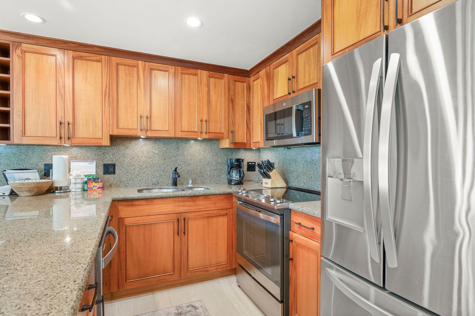 Your fully equipped kitchen features elegant cabinetry, granite counters, stainless steel appliances, and all the conveniences of home for preparing delicious meals during your stay.