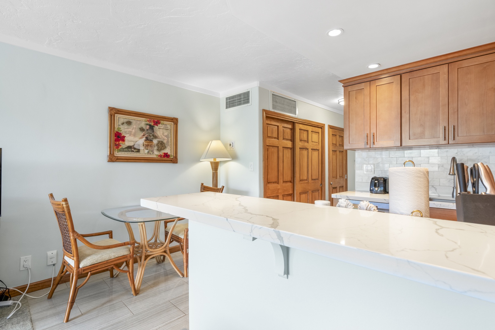 Relax at your marble-topped kitchen island, perfect for morning coffee or casual meals. Warm wood cabinetry and subway tile create a bright, welcoming space for your stay.