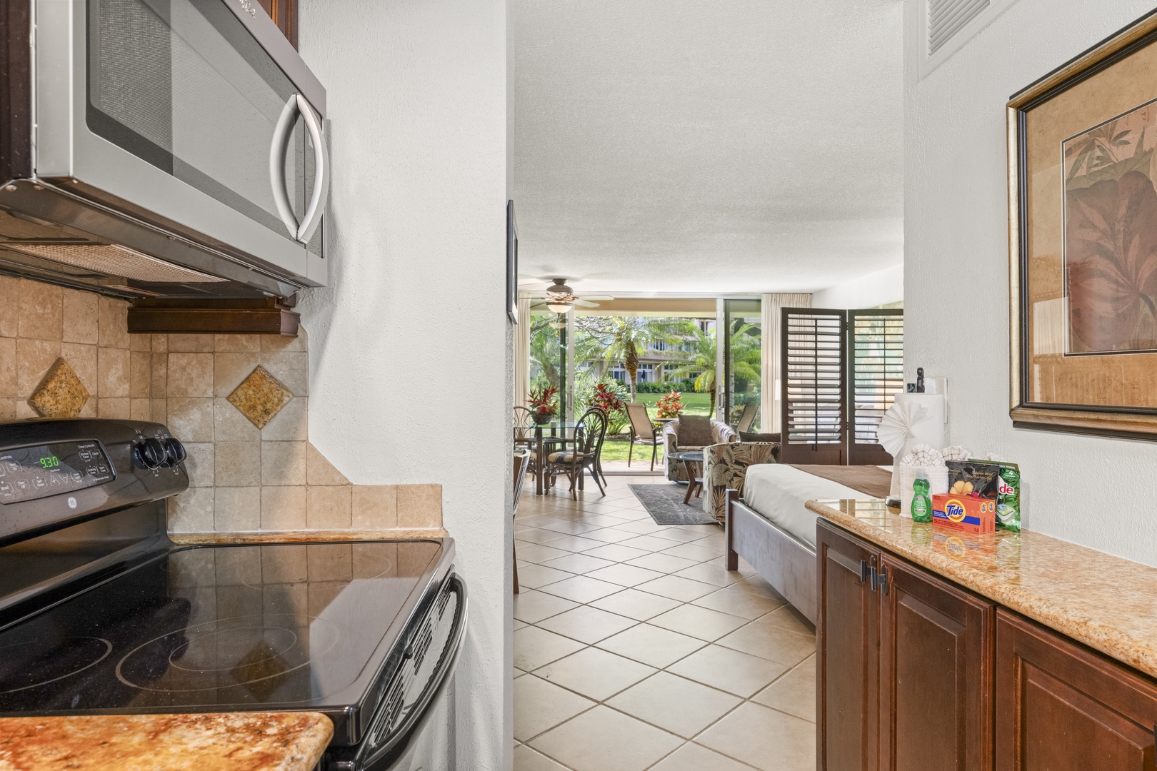 Step into your open-concept retreat where the kitchen flows seamlessly into the living space, inviting you to relax and enjoy effortless island living with tropical views beyond.