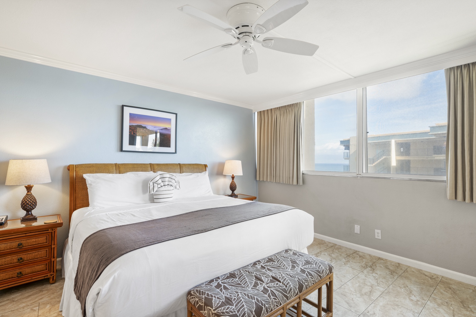 Slip into crisp, inviting linens and drift off beneath a gently whirring ceiling fan. Wake to soft light and a serene glimpse of the ocean, just steps away from your coastal retreat.