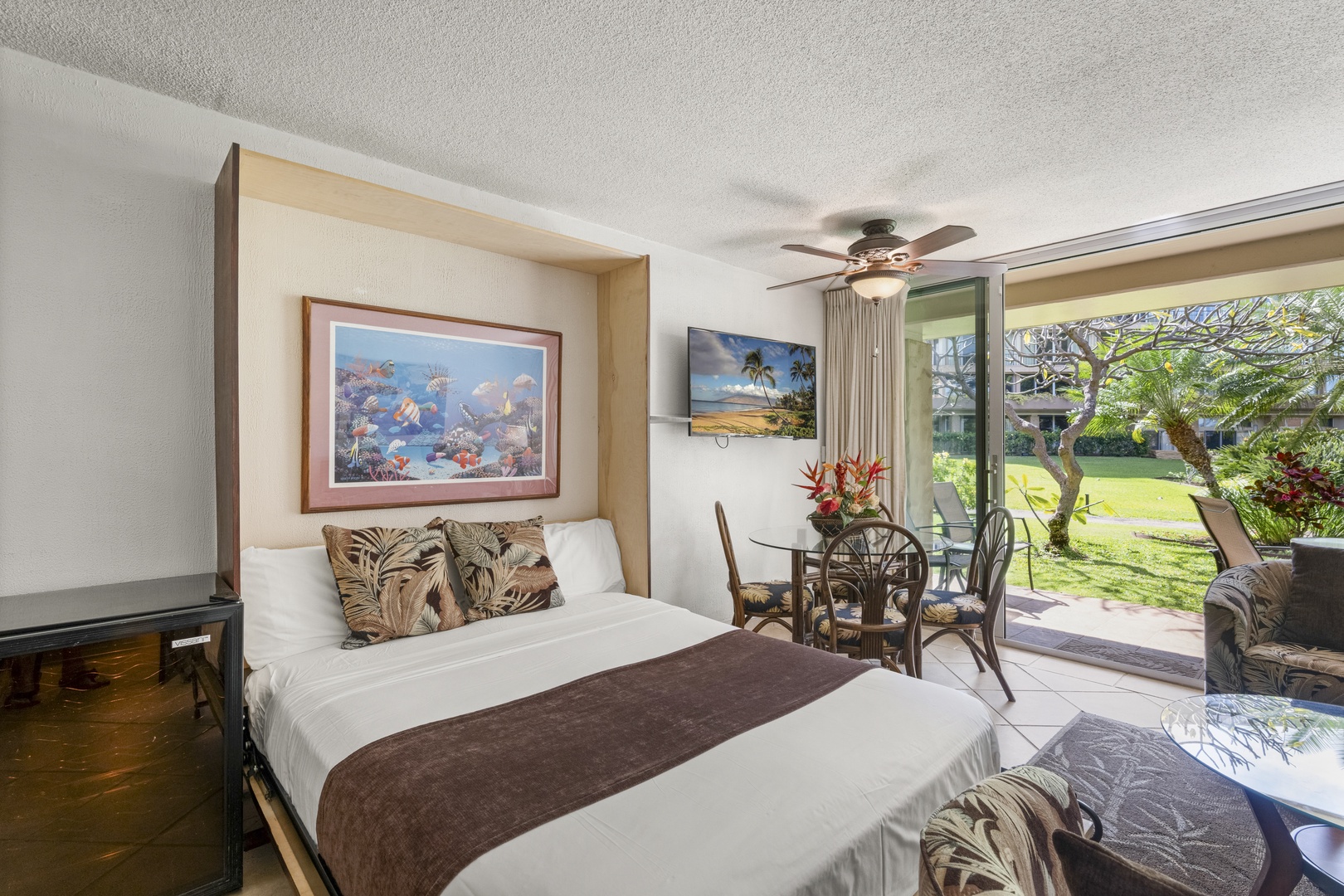 Wake up to lush garden views from your cozy bed, with a private patio just steps away. Tropical décor and ceiling fan keep your space cool and inviting.