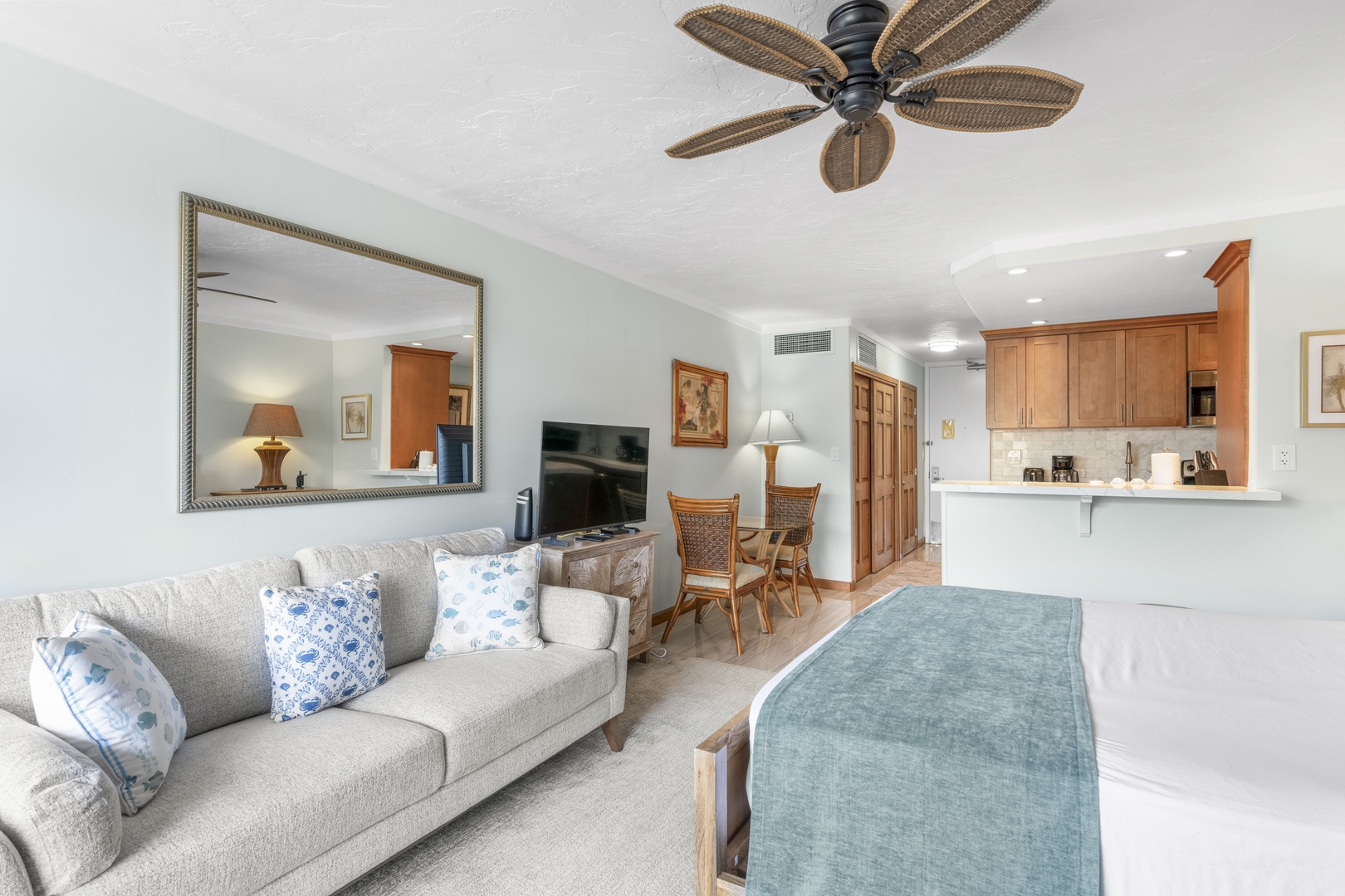 Relax in your bright, coastal-style retreat with comfortable furnishings, a tropical ceiling fan, and a fully equipped kitchen for your convenience. The open layout connects living and dining seamlessly, perfect for unwinding after island adventures.