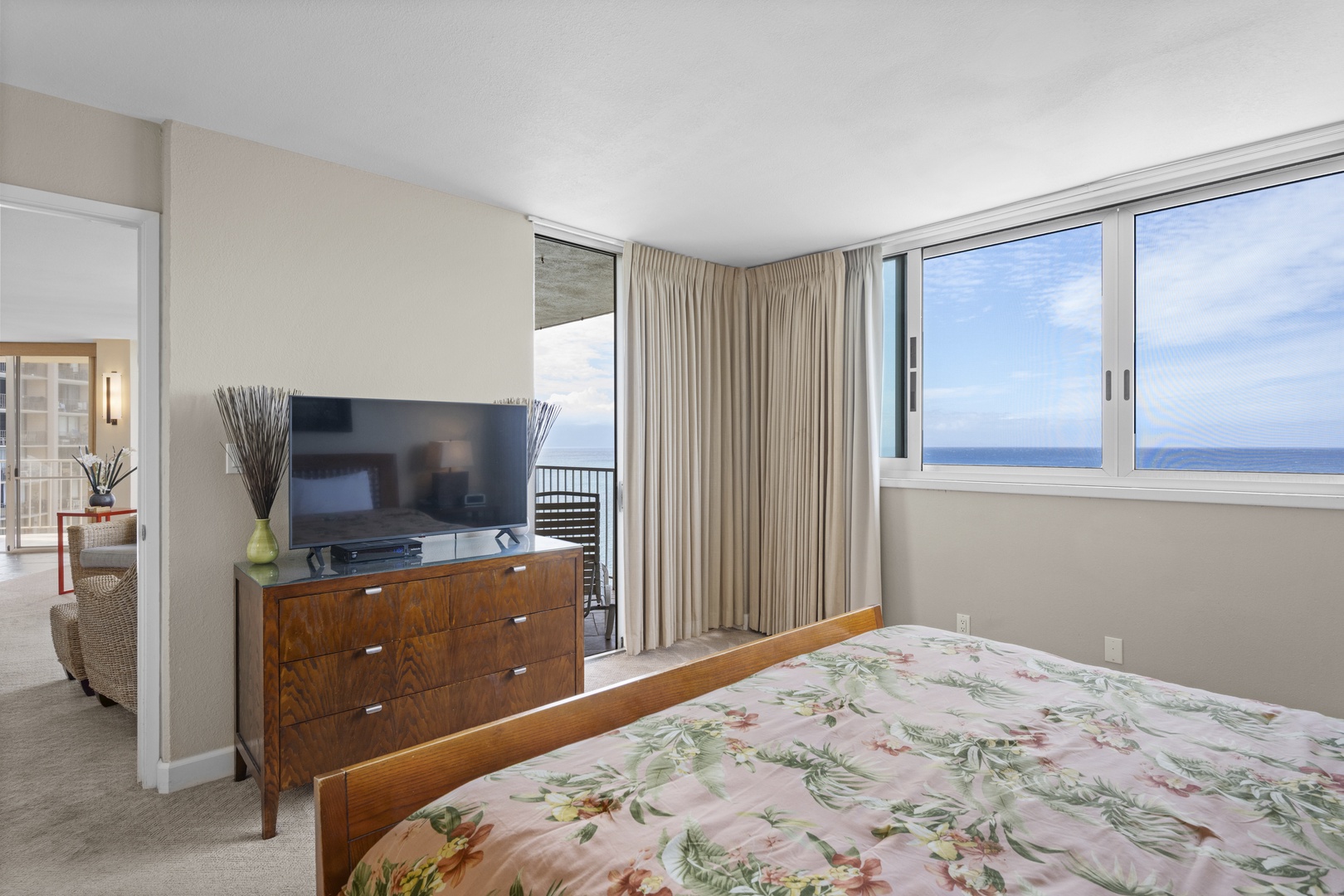 Wake up to endless ocean views through floor-to-ceiling windows in your serene bedroom retreat with modern amenities.