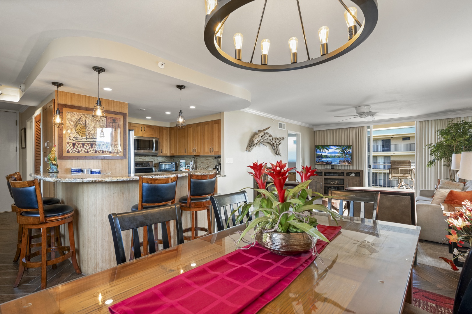 Gather around the beautiful dining table or relax at the kitchen bar in this open-concept space, where warm wood tones and coastal touches create an inviting atmosphere for your vacation meals and conversations.