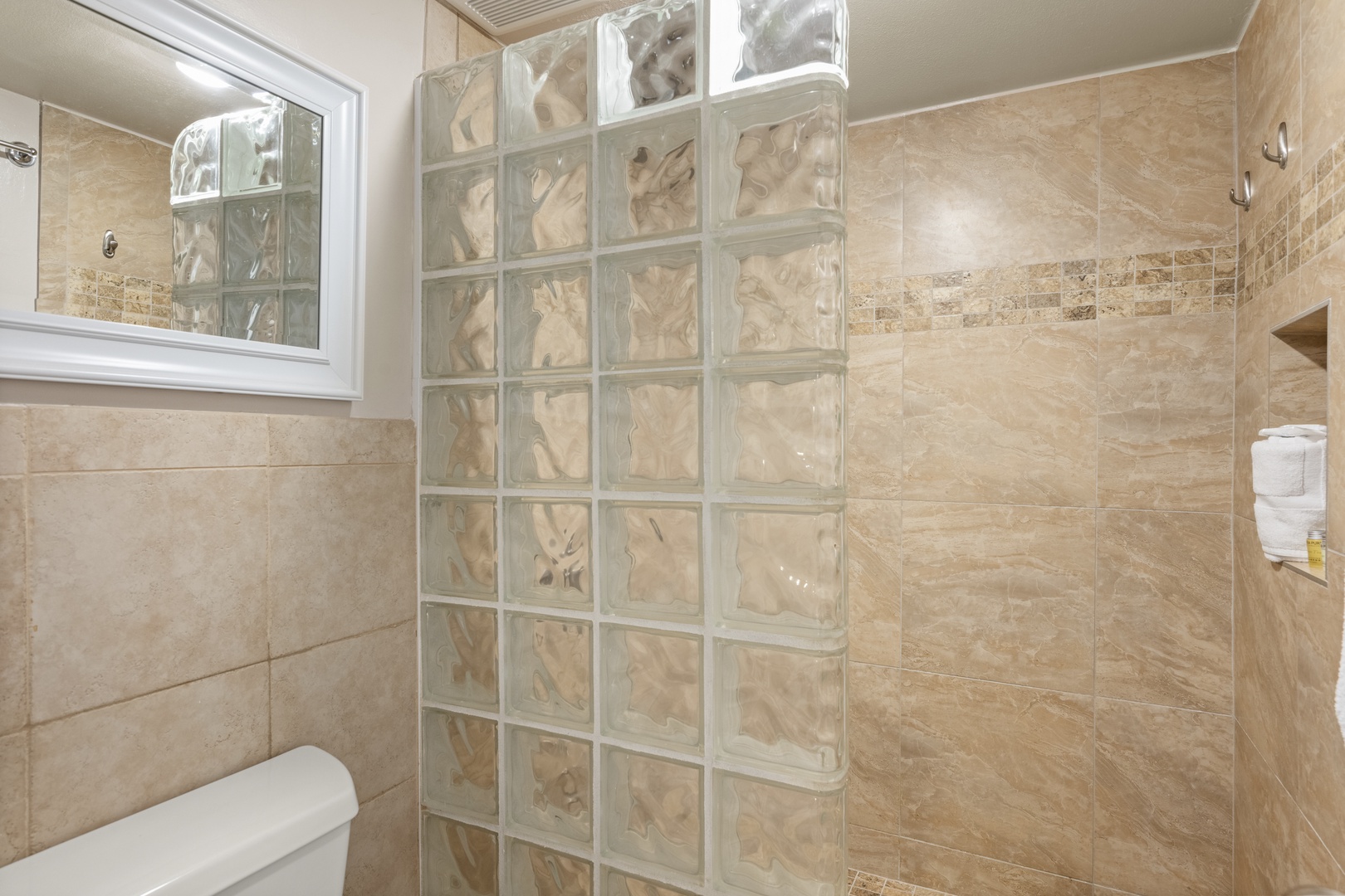Step into your beautifully tiled bathroom featuring a modern glass block shower—perfectly designed for your comfort and style.