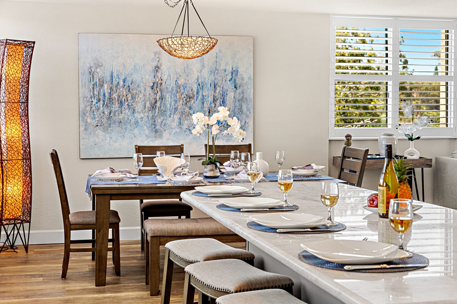 Gather around your elegant dining space, where thoughtful place settings and artistic touches create the perfect atmosphere for memorable meals together.
