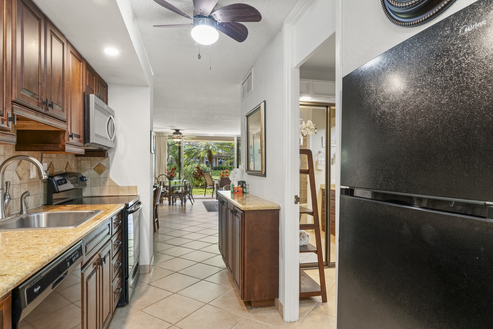 Your fully-equipped kitchen features rich wood cabinetry, granite counters, and stainless appliances—everything you need to whip up meals at home and enjoy the open, airy layout that flows effortlessly into your living and dining spaces.