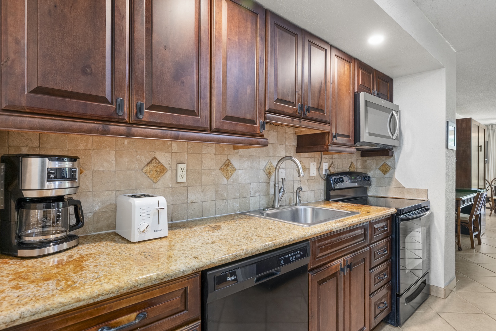 Your well-equipped kitchen awaits with granite countertops, rich wood cabinetry, and stainless steel appliances—everything you need to whip up your favorite meals in comfort.