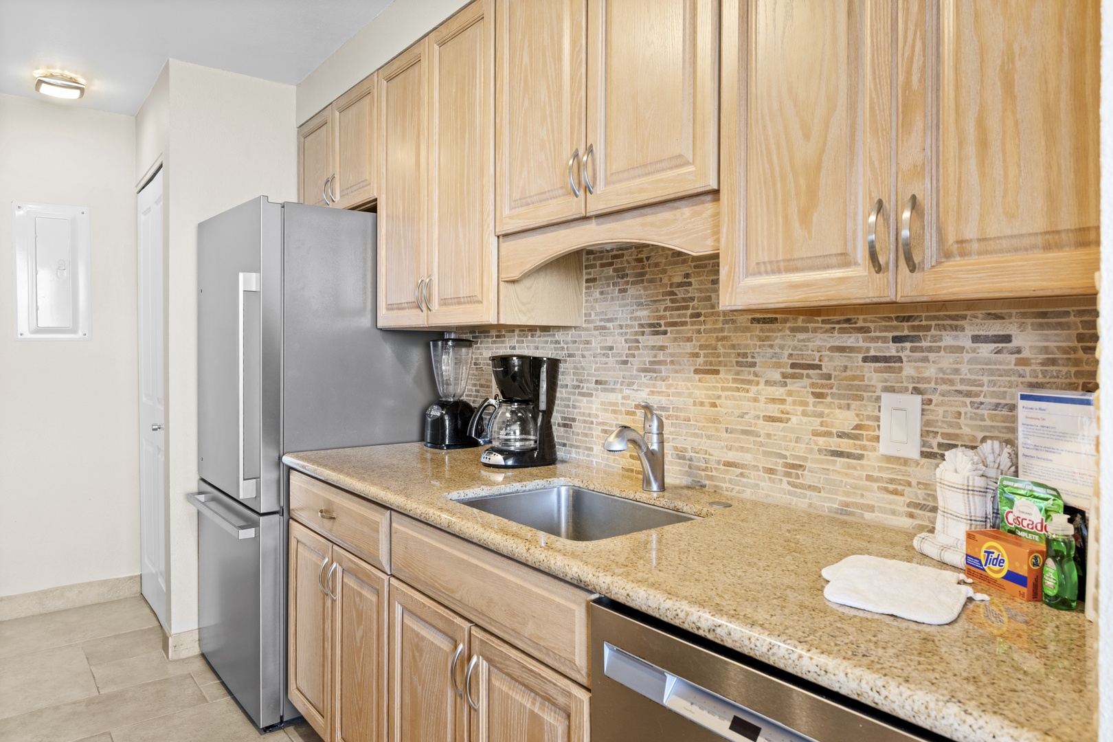 Step into your fully equipped kitchen, featuring warm wood cabinets, granite counters, and modern appliances ready for your culinary adventures.