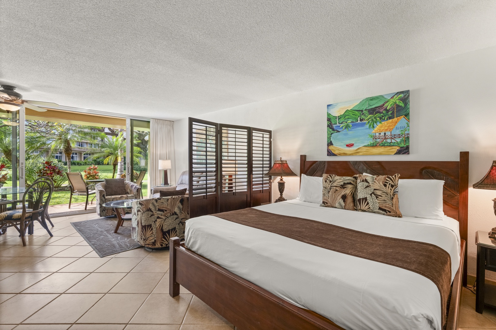 Unwind in your tropical retreat with plush bedding, island-inspired décor, and a private patio opening to lush garden views—your personal paradise awaits.