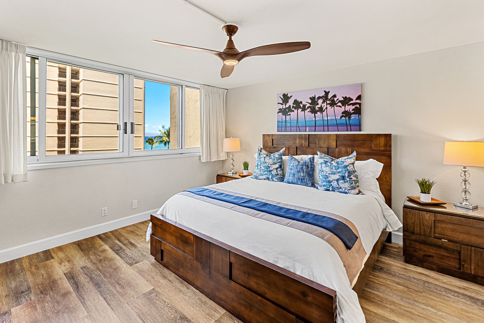 Drift off to peaceful sleep in your coastal bedroom, where tropical artwork and ocean views create the perfect beachside retreat.